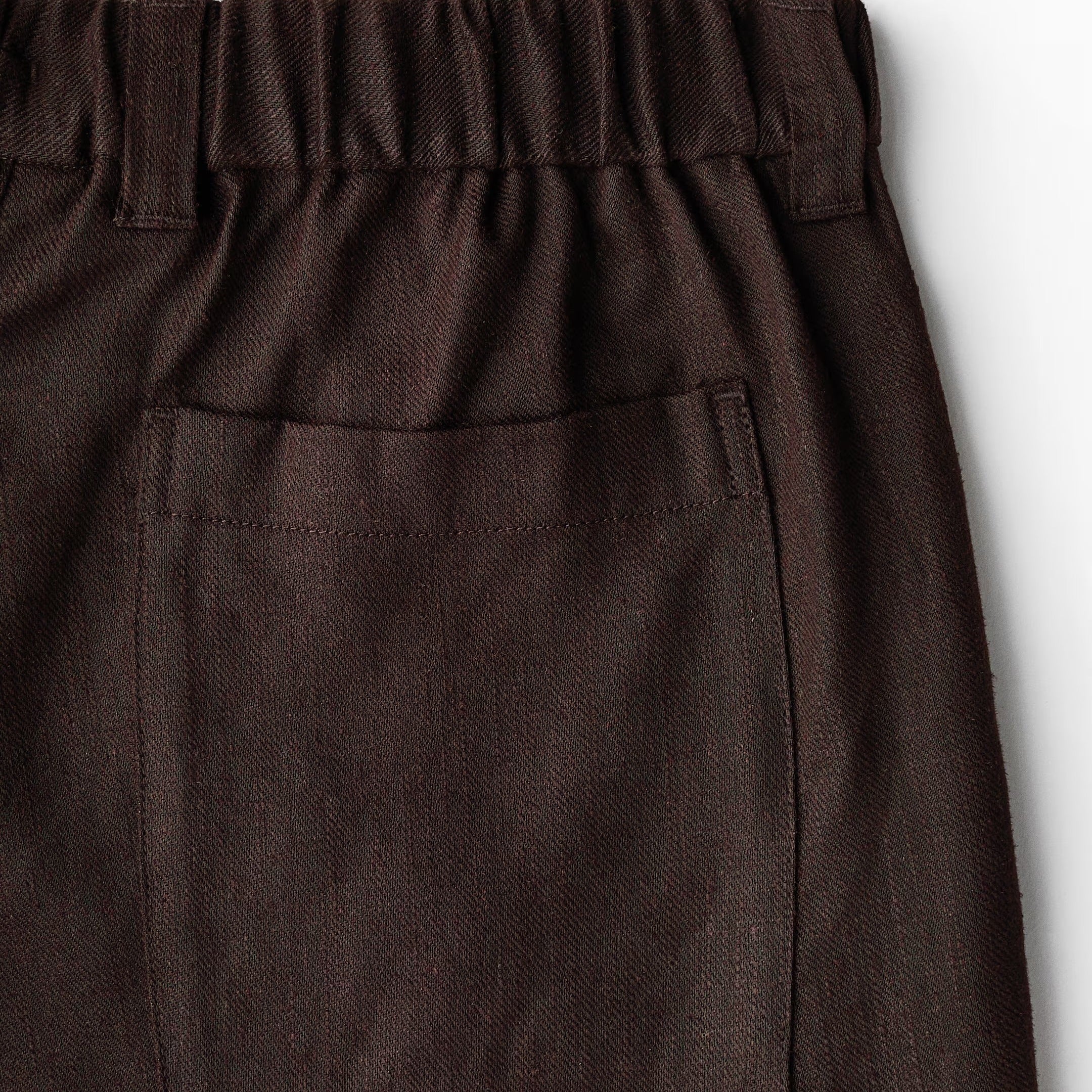 Dark gray pants with an elastic waistband on a white background